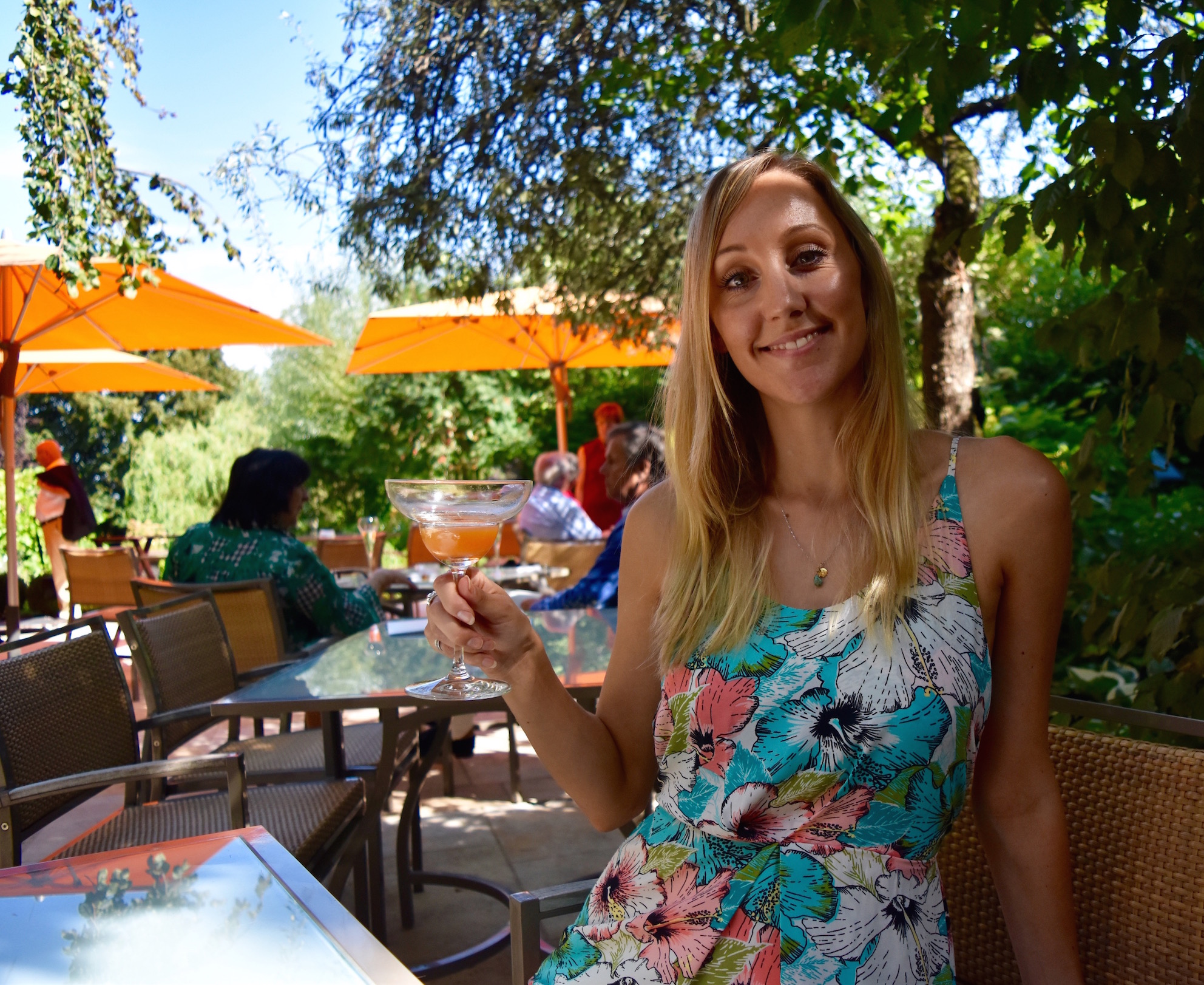Hayley with a cocktail in a restaurant garden