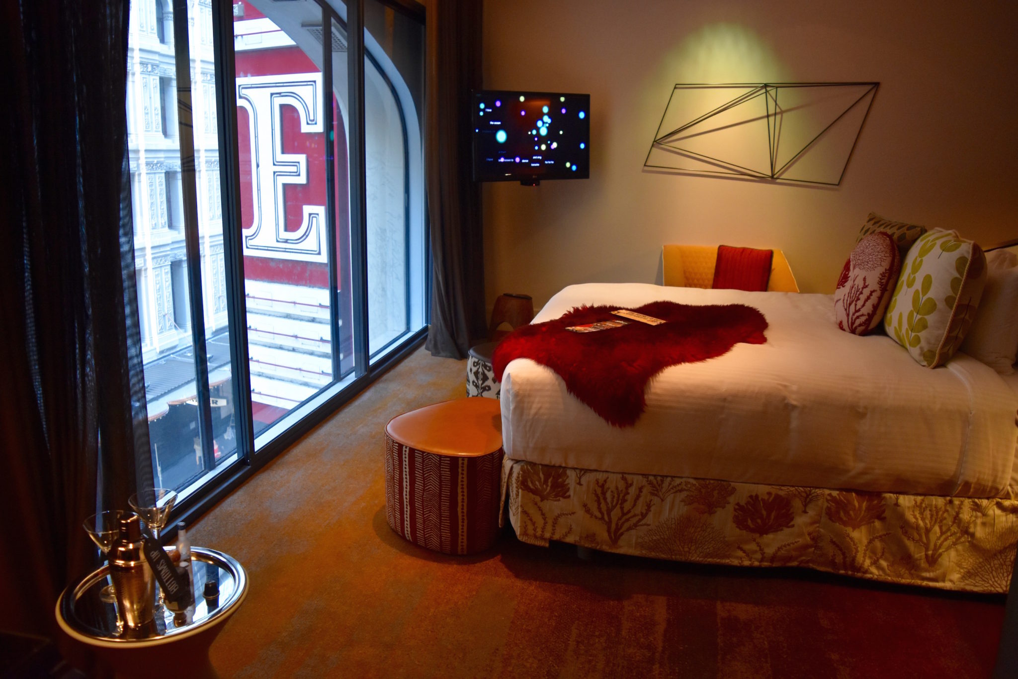A double bed overlooking the State Theatre sign