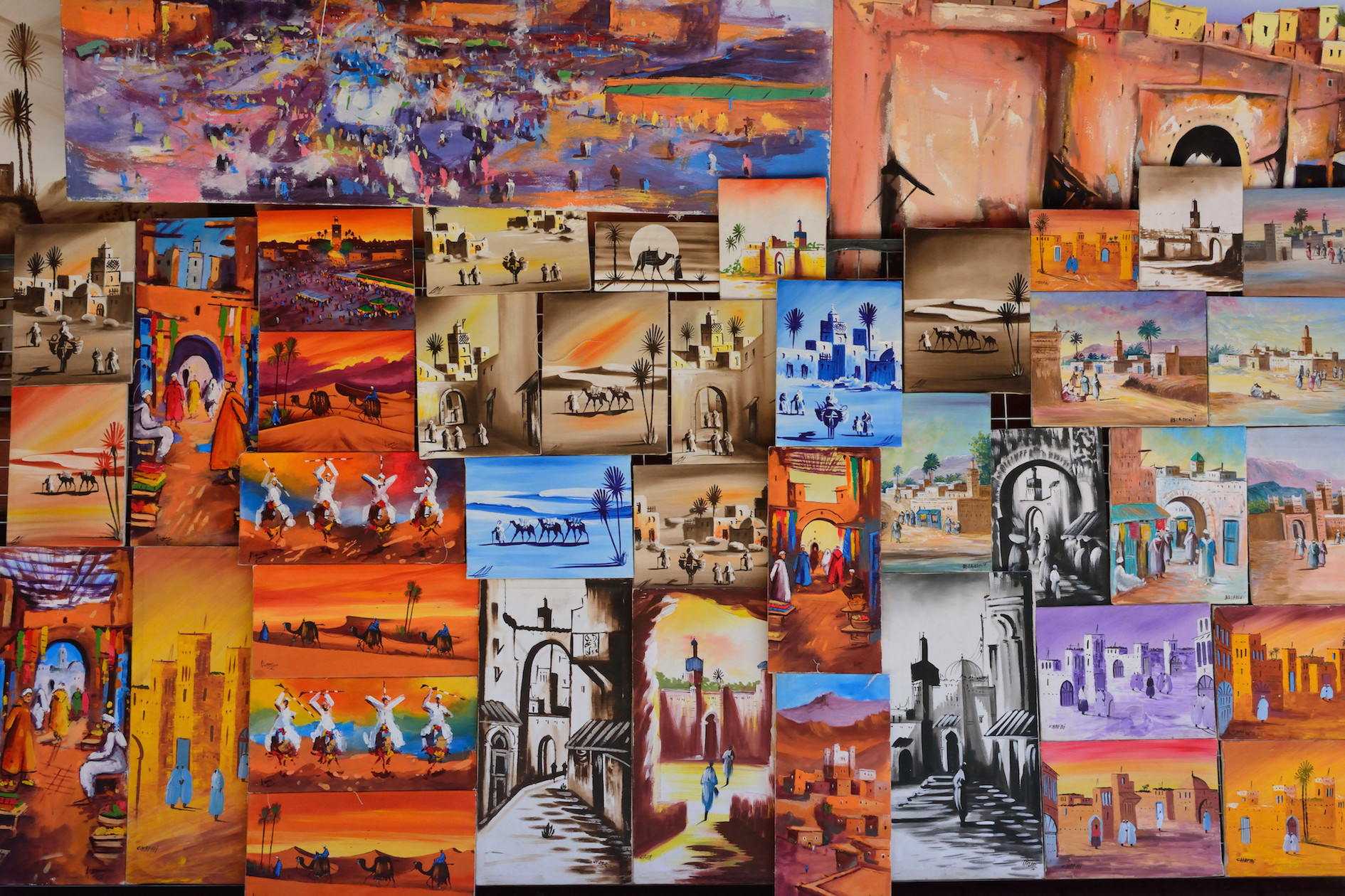 A wall of colourful artworks featuring Moroccan imagery