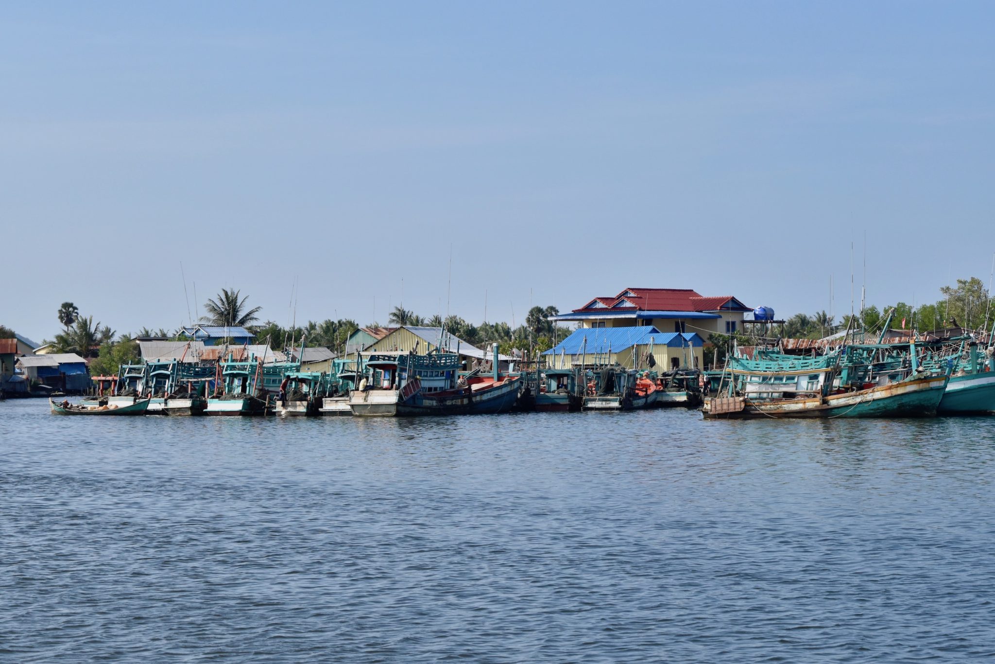 Boats line the Preaek Tuek Chhu River