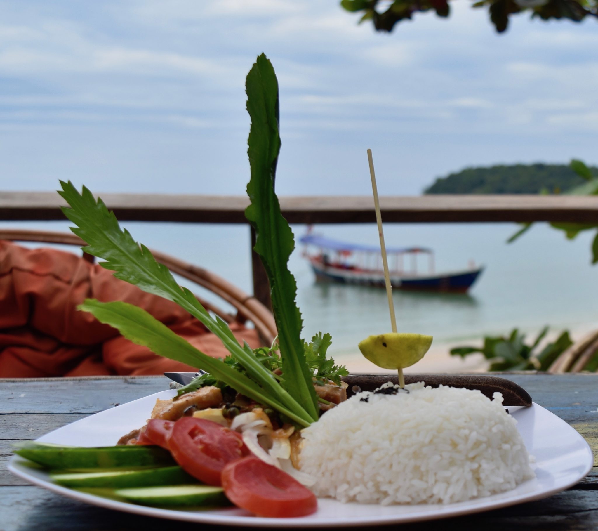 A dish of Cambodian food overlooking the beach 