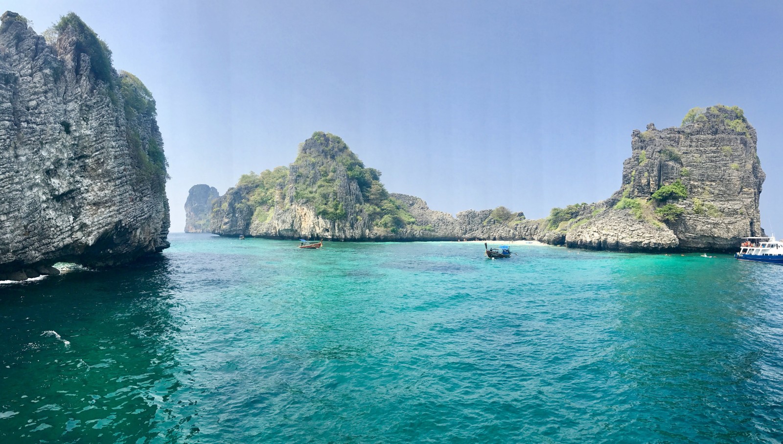 Rock formations rise from turquoise water in the Andaman Coast