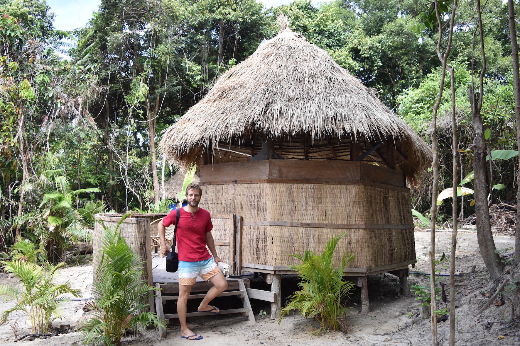 Enrico standing in front of a bamboo hut at Koh Ta Kiev