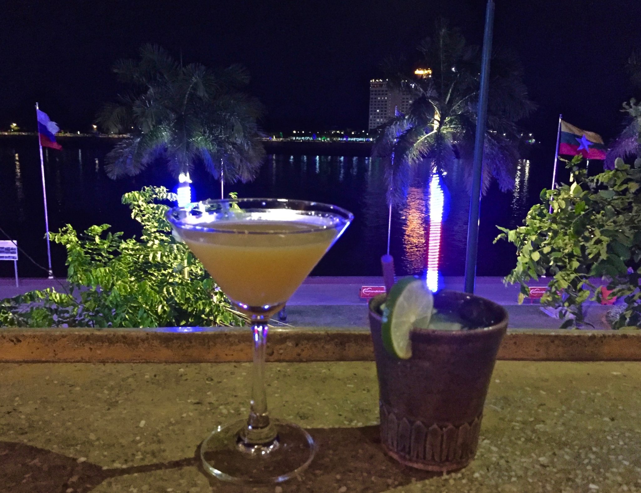Two cocktails on a bar overlooking the Mekong River
