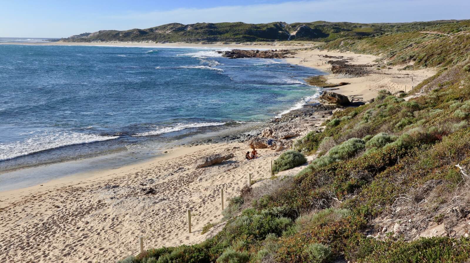 Prevally in Margaret River. Green scrub leads to white sand and the blue ocean. 