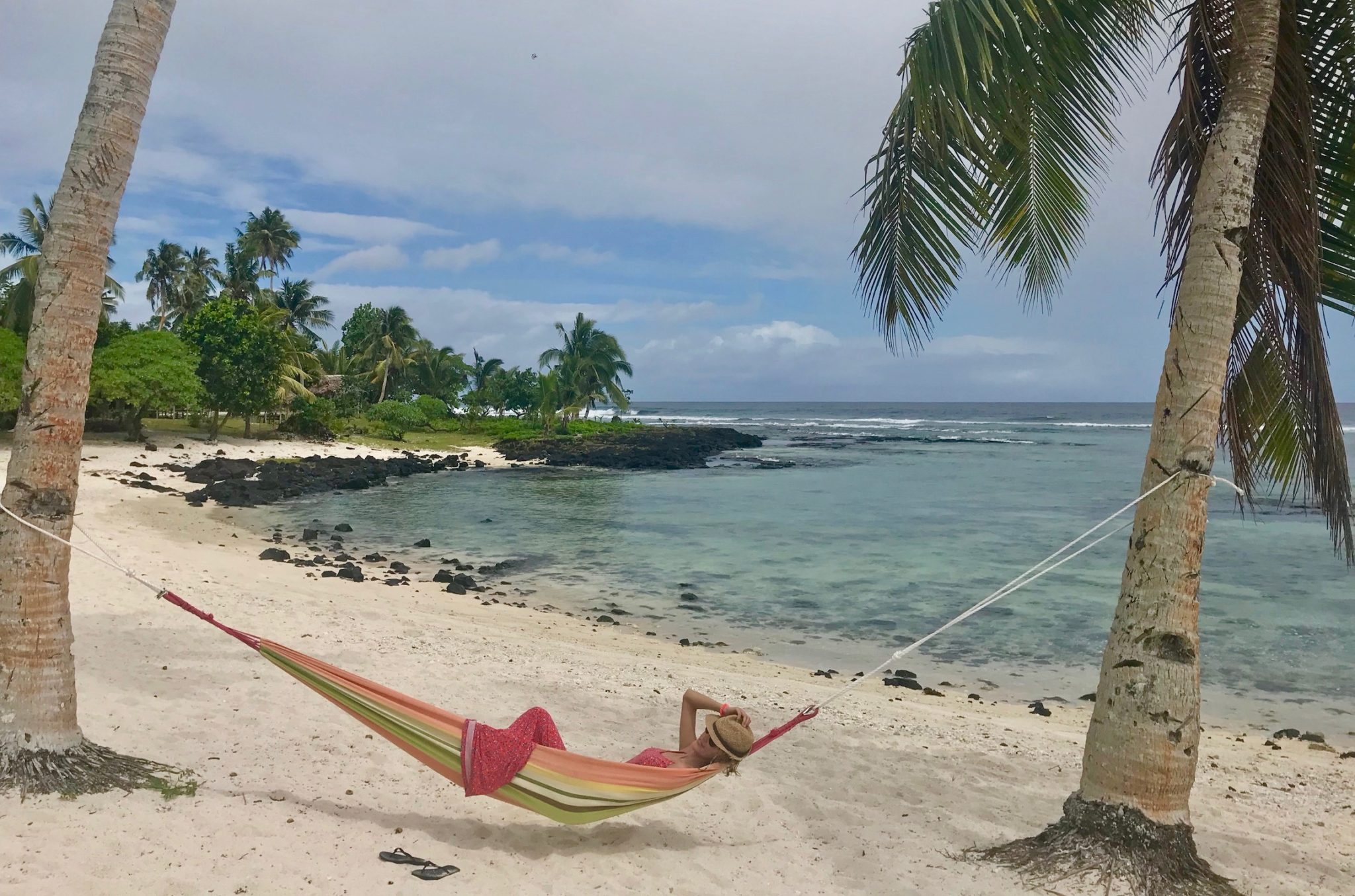 Hayley relaxing in a hammock on a beach in Upolu, Samoa