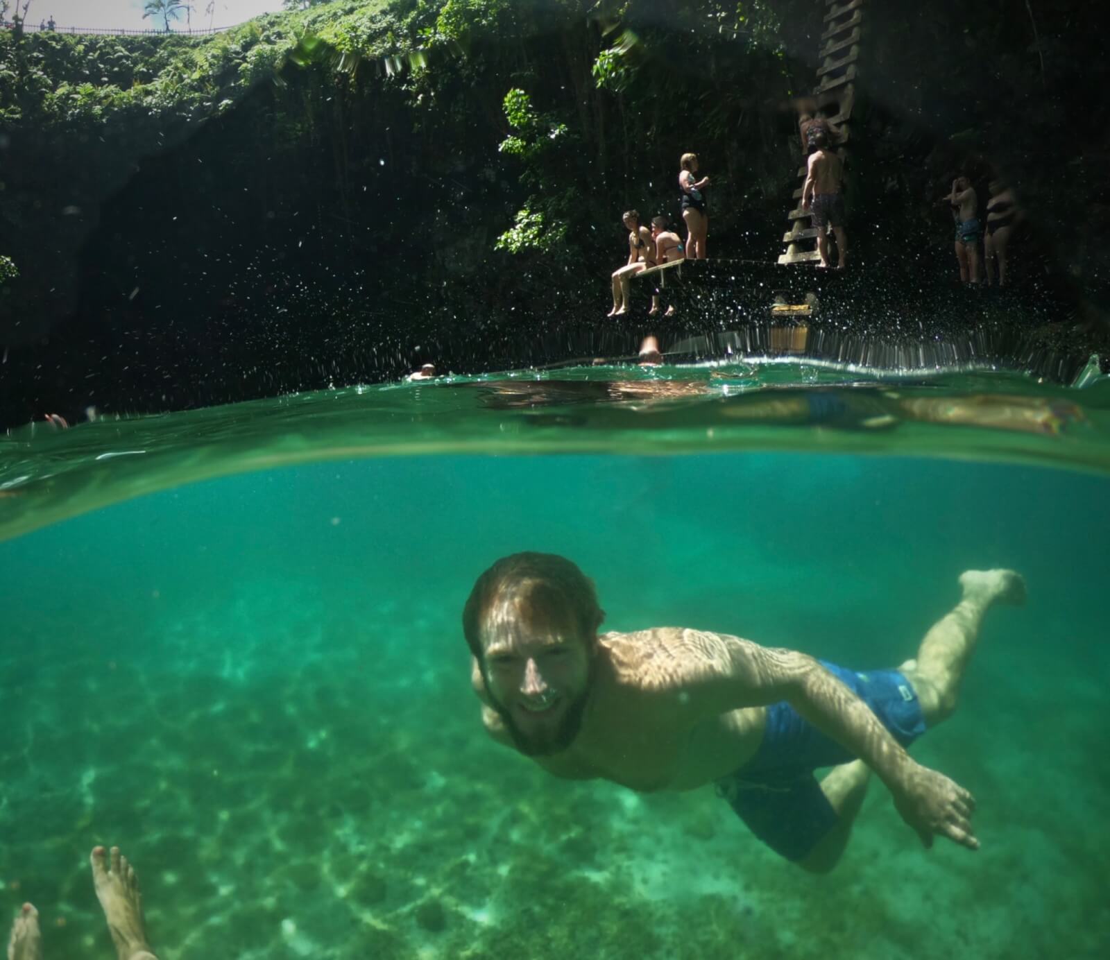 Enrico swimming underwater in To Sua Ocean Trench - one of the best things to do in Upolu, Samoa