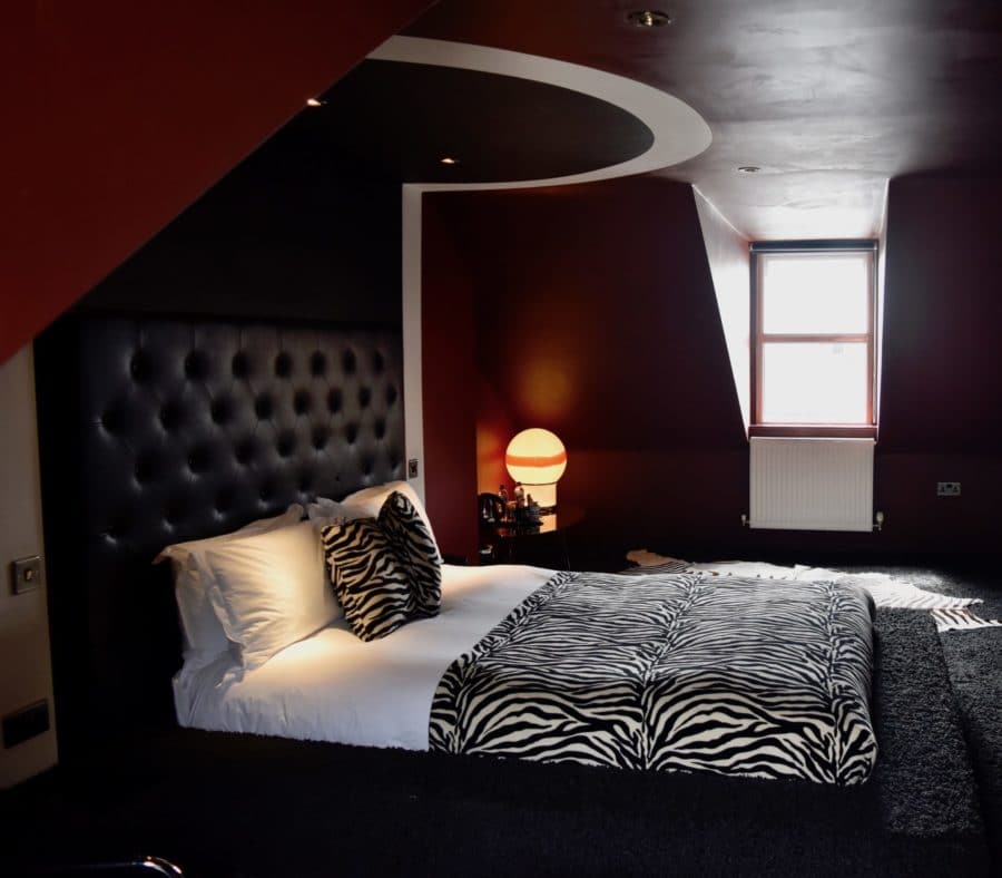 Zebra print bedsheets and red walls at Snooze Brighton